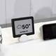 The demo e-ink screen sits in the middle, flanked by Lenovo’s new $80 Smart Clock on the right.